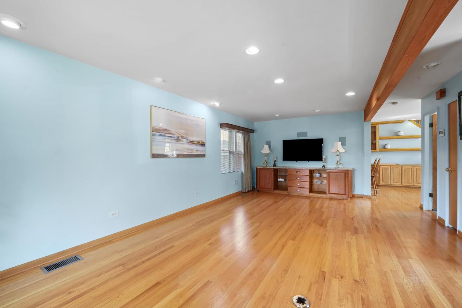 5751 South Monitor Avenue Chicago, IL 60638 - Photo 3 of 30 a living room with hard wood floors and a flat screen tv
