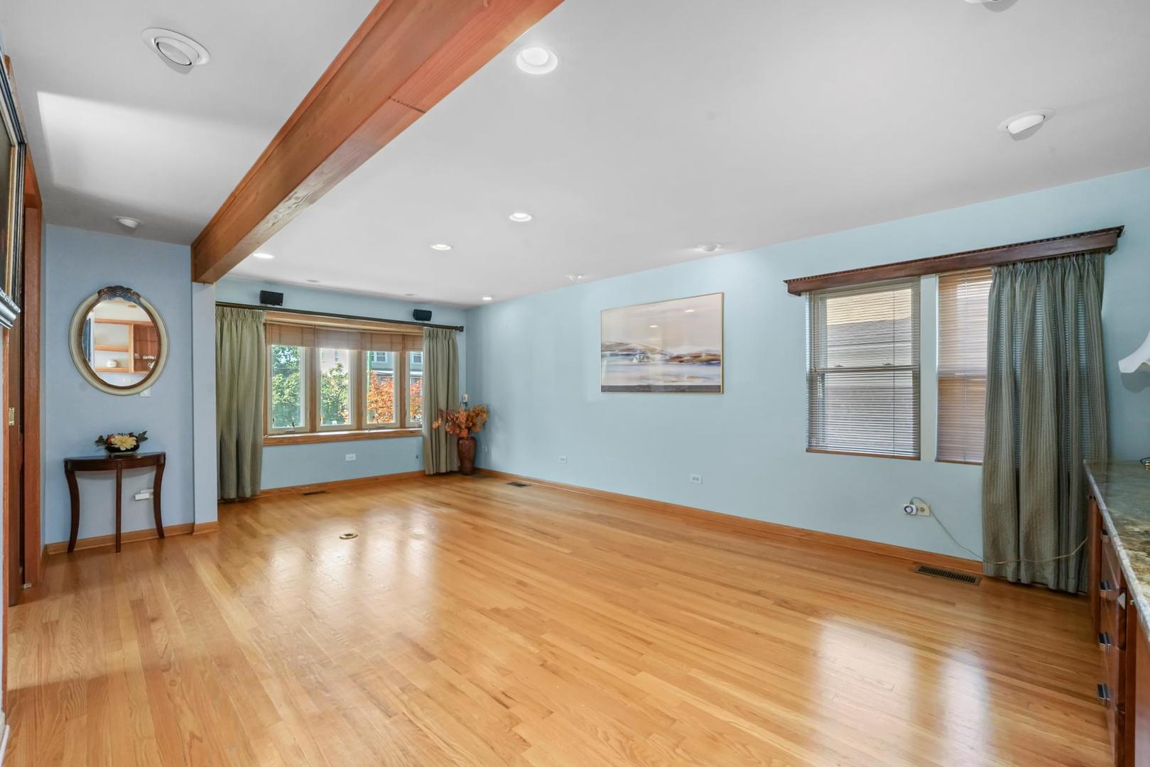 5751 South Monitor Avenue Chicago, IL 60638 - Photo 5 of 30 a view of an empty room with a window and wooden floor