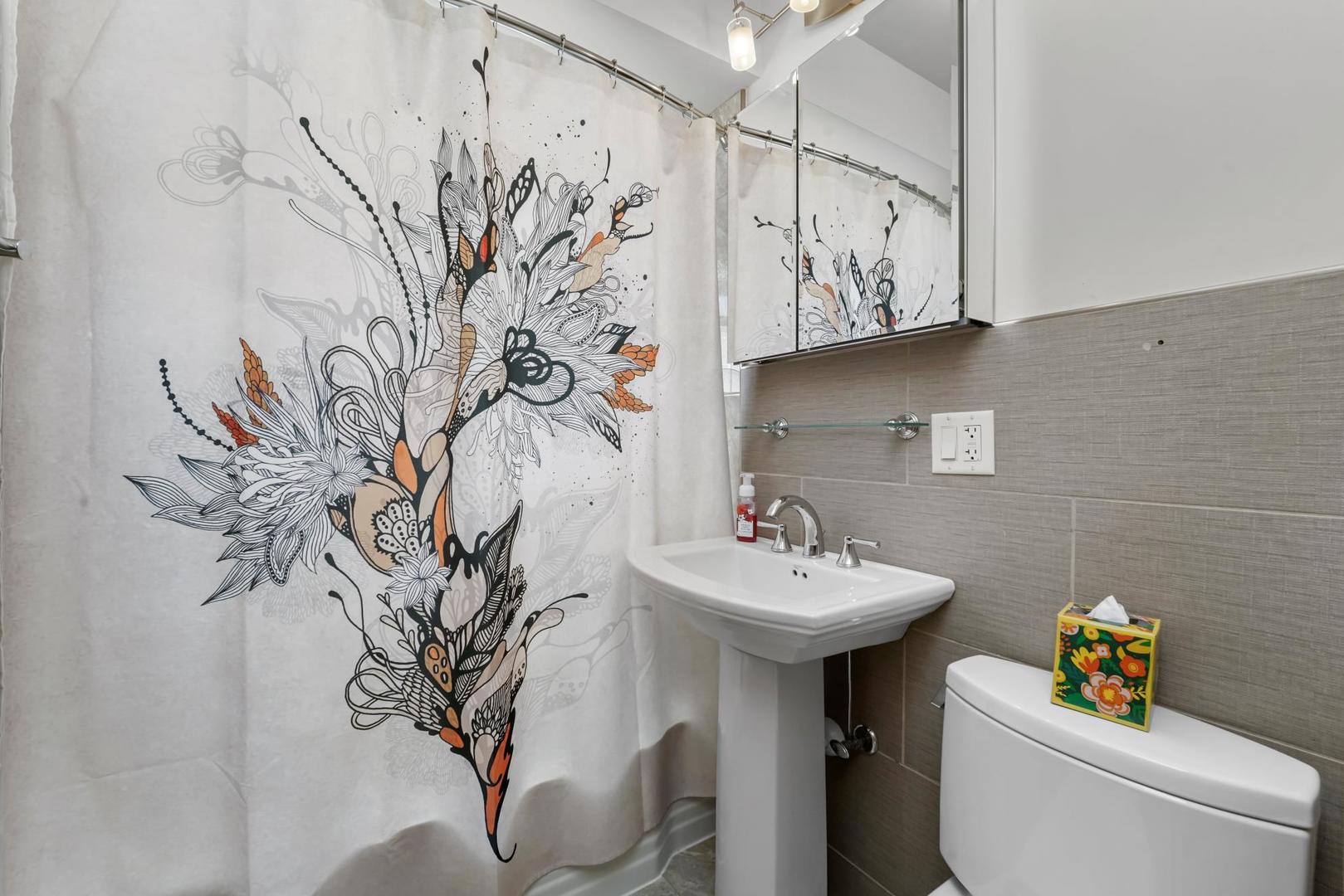 5751 South Monitor Avenue Chicago, IL 60638 - Photo 7 of 30 a bathroom with a sink and mirror with toilet