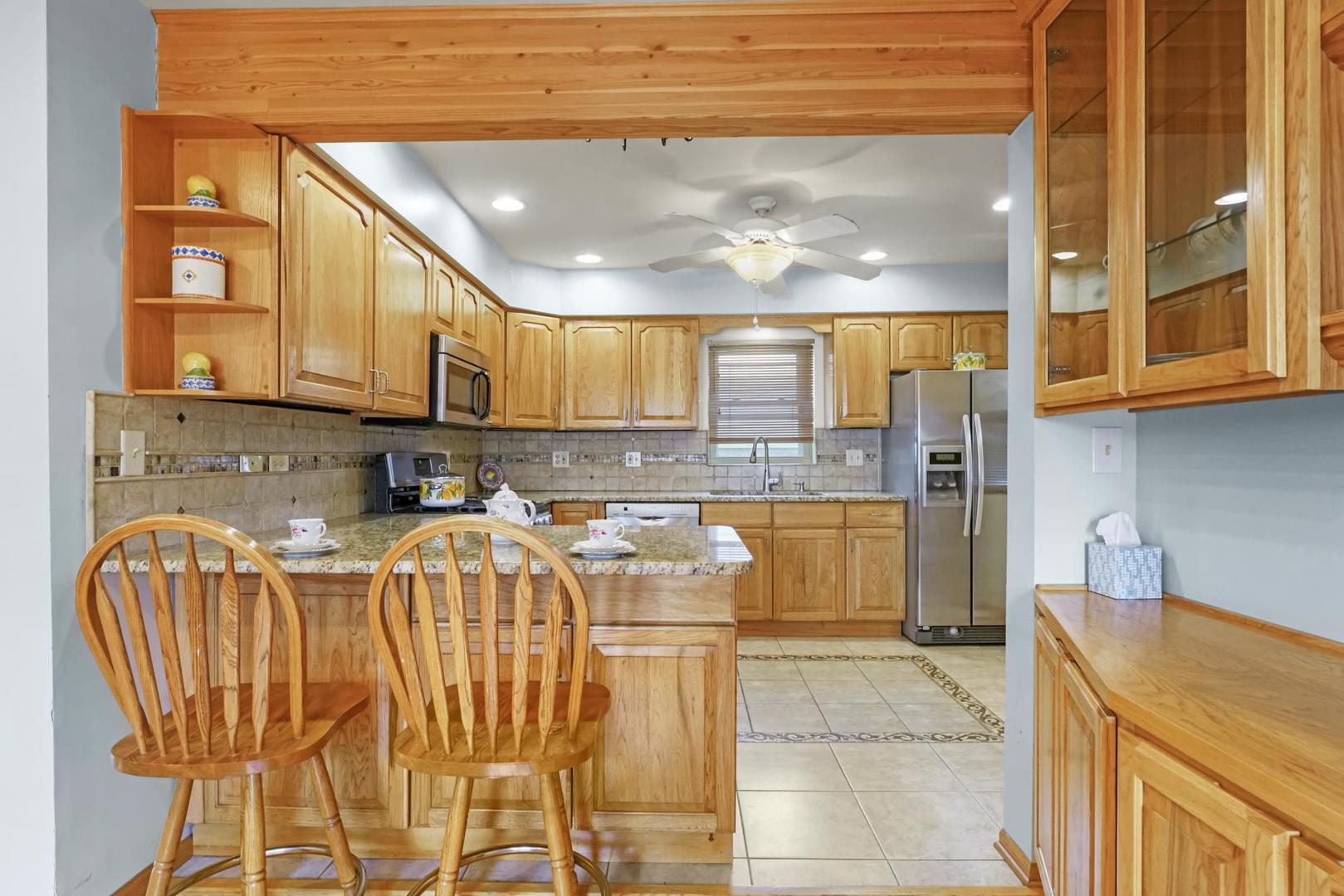 5751 South Monitor Avenue Chicago, IL 60638 - Photo 9 of 30 a kitchen with stainless steel appliances granite countertop a sink and cabinets