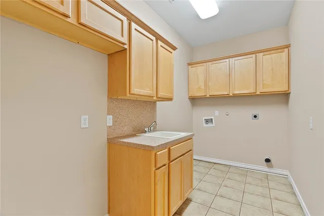 a utility room with sink dryer and washer