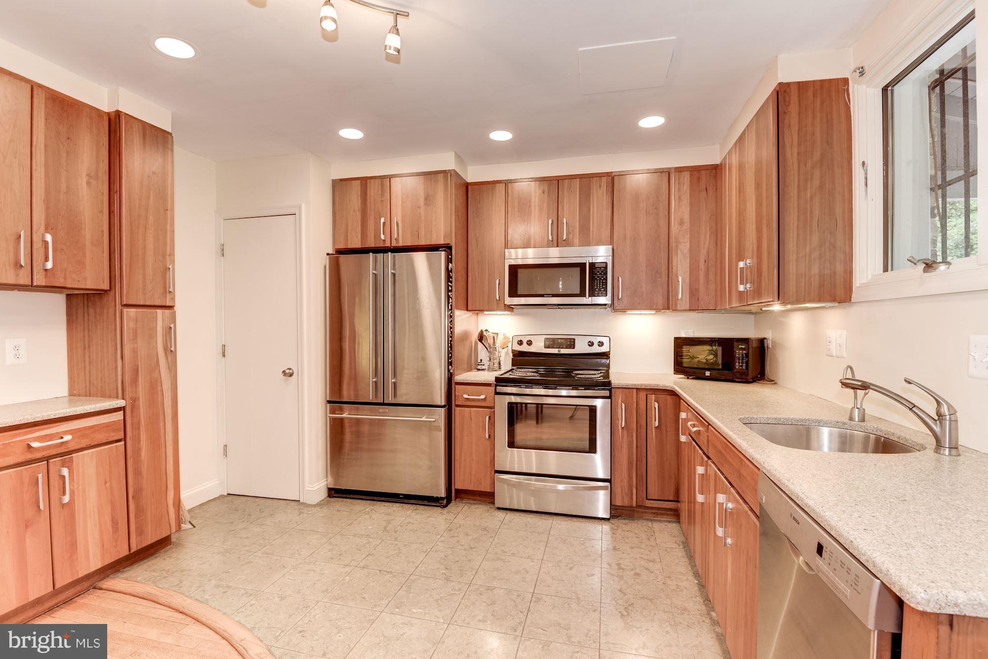 a kitchen with a refrigerator sink and microwave