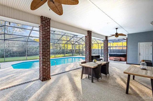 a dining room with furniture and a floor to ceiling window