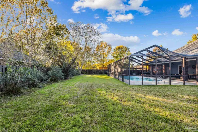 a view of a house with a big yard and a fountain