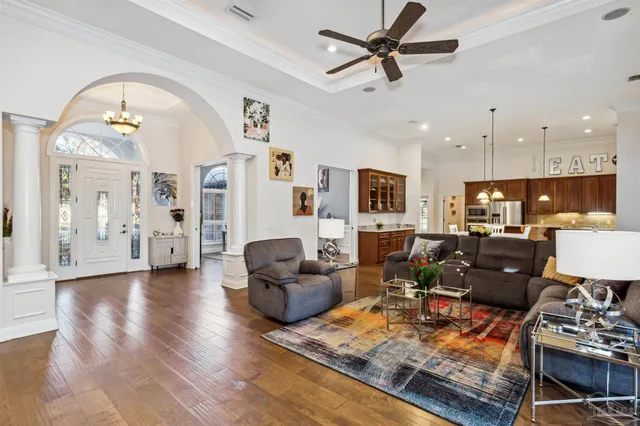 a living room with fireplace furniture and a wooden floor