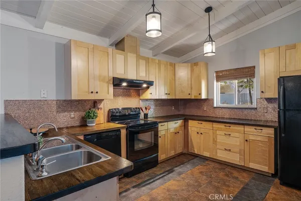 a kitchen with a refrigerator and a stove top oven