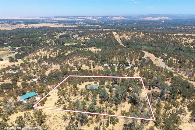 a view of a yard covered with snow in front of house