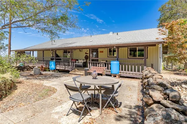 a view of a patio with a table and chairs under an umbrella