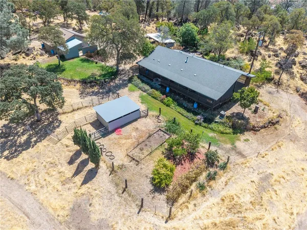 a front view of a house with a yard covered with snow