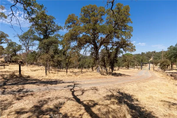 a view of a yard covered with snow in front of house