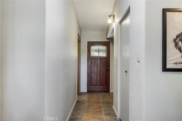 a living room with furniture and a painting on the wall
