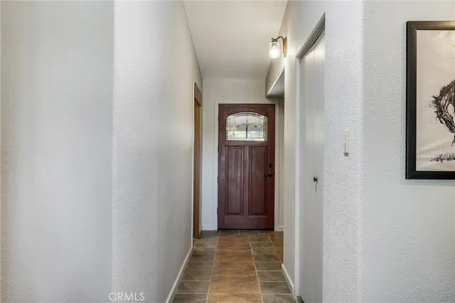a living room with furniture and a painting on the wall