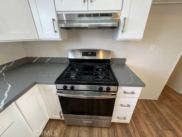 a stove top oven sitting inside of a kitchen