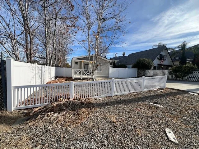 a view of a house with a wooden fence