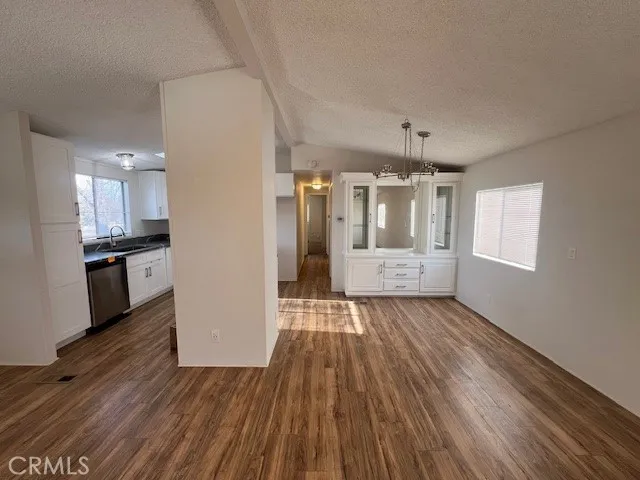 a view of a kitchen with wooden floor and a kitchen