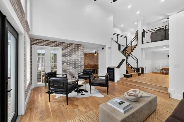 a living room with furniture and wooden floor