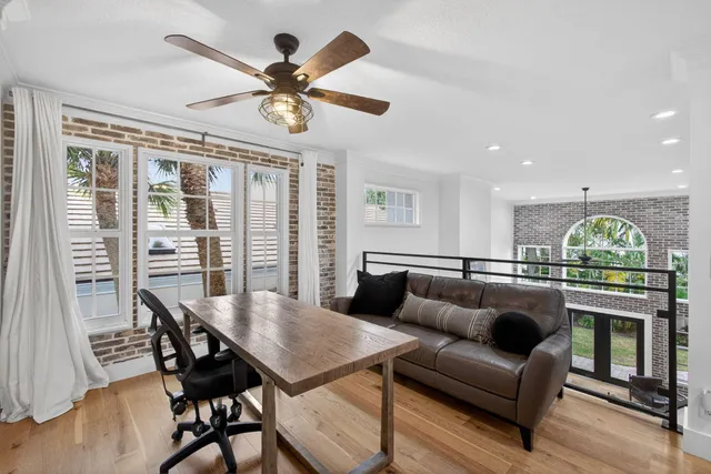 a view of a livingroom with furniture and a large window