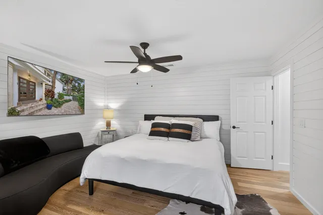 a bedroom with a bed and a painting on the wall