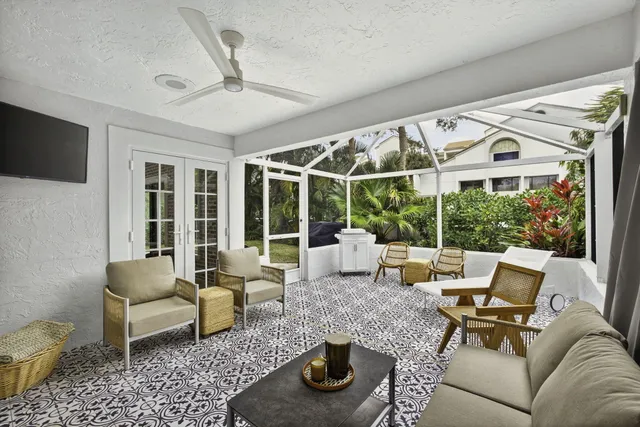 a living room with furniture and a floor to ceiling window