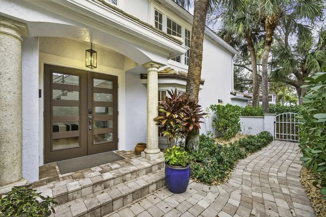 a view of a house with potted plants