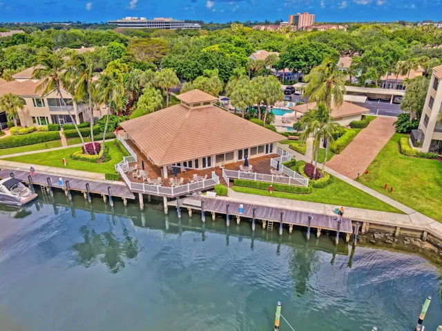 a view of a swimming pool with lawn chairs under an umbrella