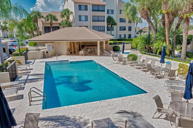 a view of a house with backyard patio and sitting area