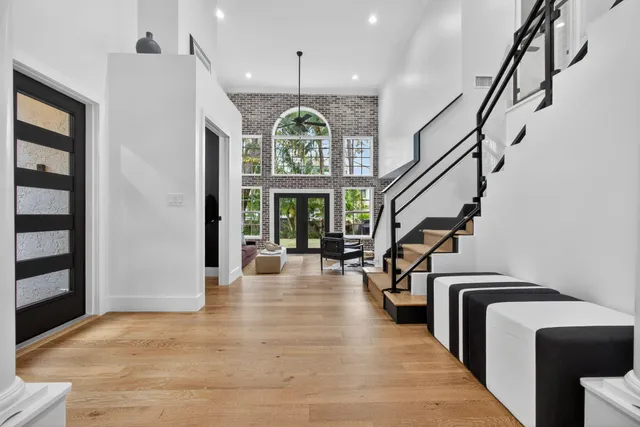 a view of an entryway with wooden floor and a livingroom