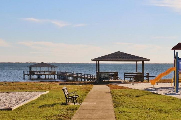 2363 Knotty Pine Drive Navarre, FL 32566 - Photo 15 of 33 a view of a swimming pool with couches chairs