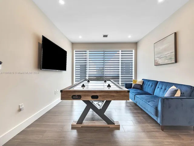 a view of a livingroom with furniture and flat screen tv