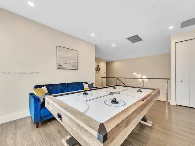 a spacious bedroom with a large bed and a chandelier