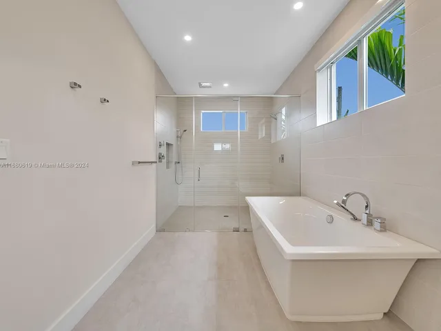 a view of a walk in closet and wooden floor