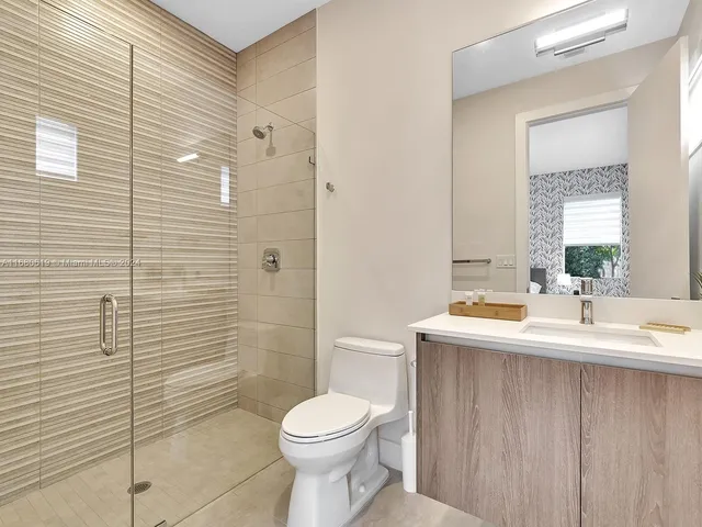 a living room with furniture and view of kitchen