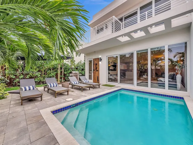 a view of a patio with swimming pool table and chairs