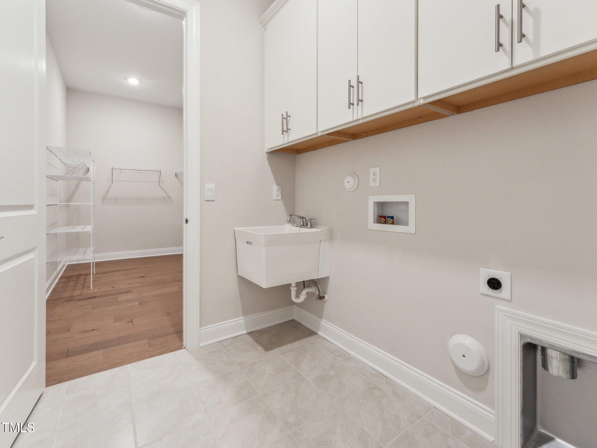 208 Regency Rdg Drive Holly Springs, NC 27540 - Photo 8 of 45 Laundry room with access to the primary closet for the utmost convenience