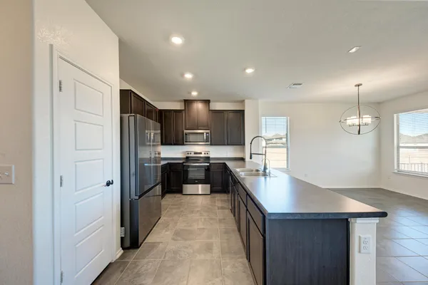 a kitchen with granite countertop stainless steel appliances and refrigerator