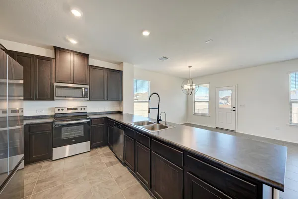 a kitchen with a sink cabinets and window