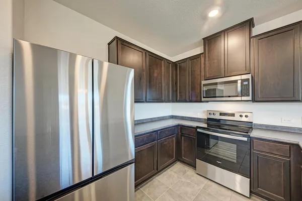 a kitchen with a sink and a large mirror next to a window