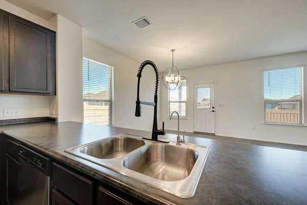 a bathroom with a sink a light fixture and a mirror