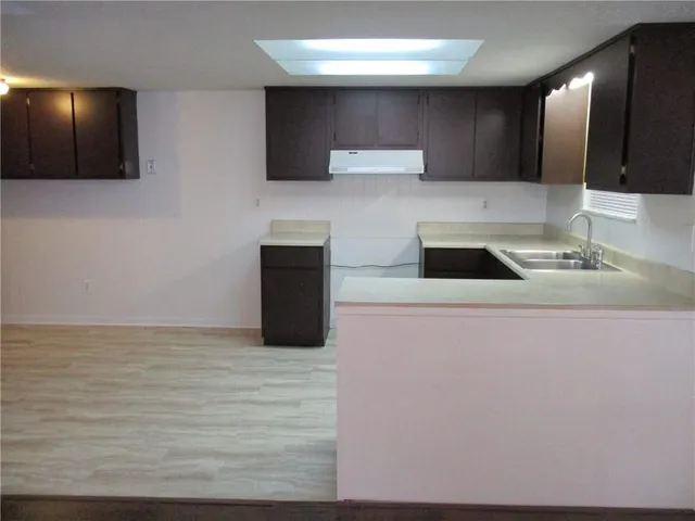 a kitchen with a sink and a stove top oven