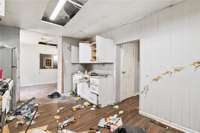a kitchen with a sink appliances and cabinets