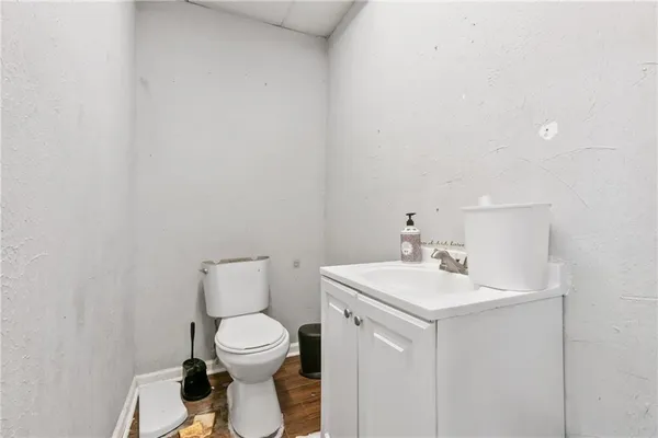 a bathroom with a toilet a sink and a mirror