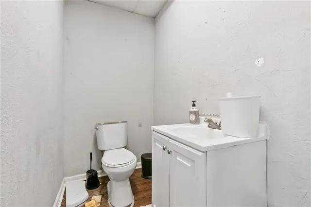 a bathroom with a toilet a sink and a mirror