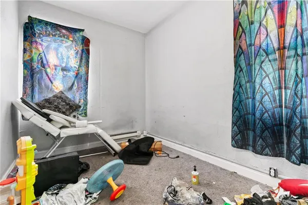 a living room with furniture and a wall painting