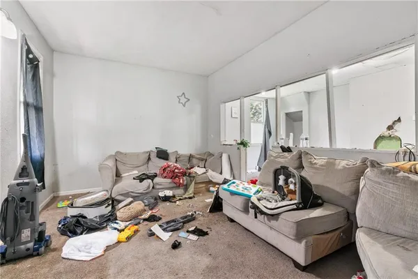 a living room with furniture and next to a window