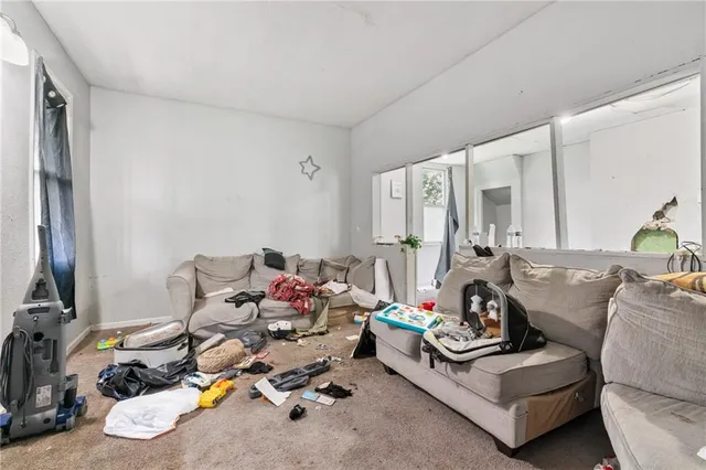 a living room with furniture and next to a window