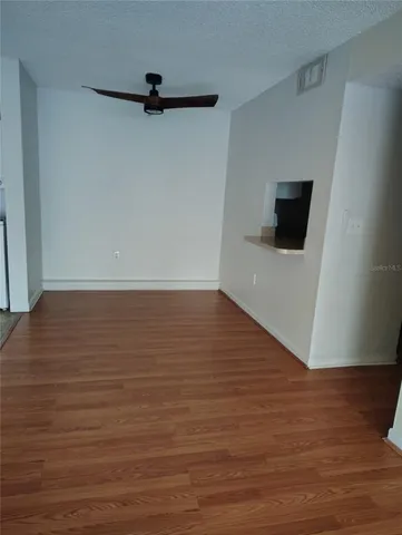 a view of a livingroom with wooden floor and a window