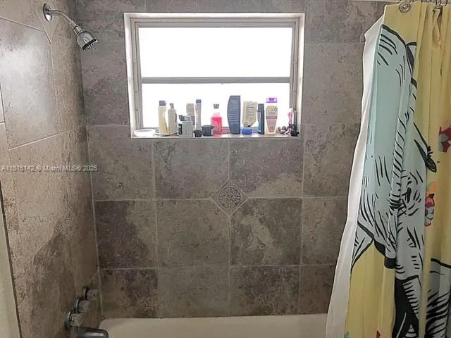 a bathroom with a bathtub and a window