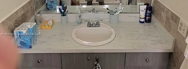 a bathroom with a sink and mirror