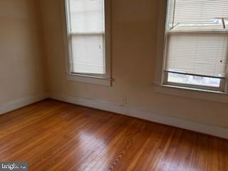 5945 Addison Road Capitol Heights, MD 20743 - Photo 2 of 9 a view of an empty room with wooden floor and a window
