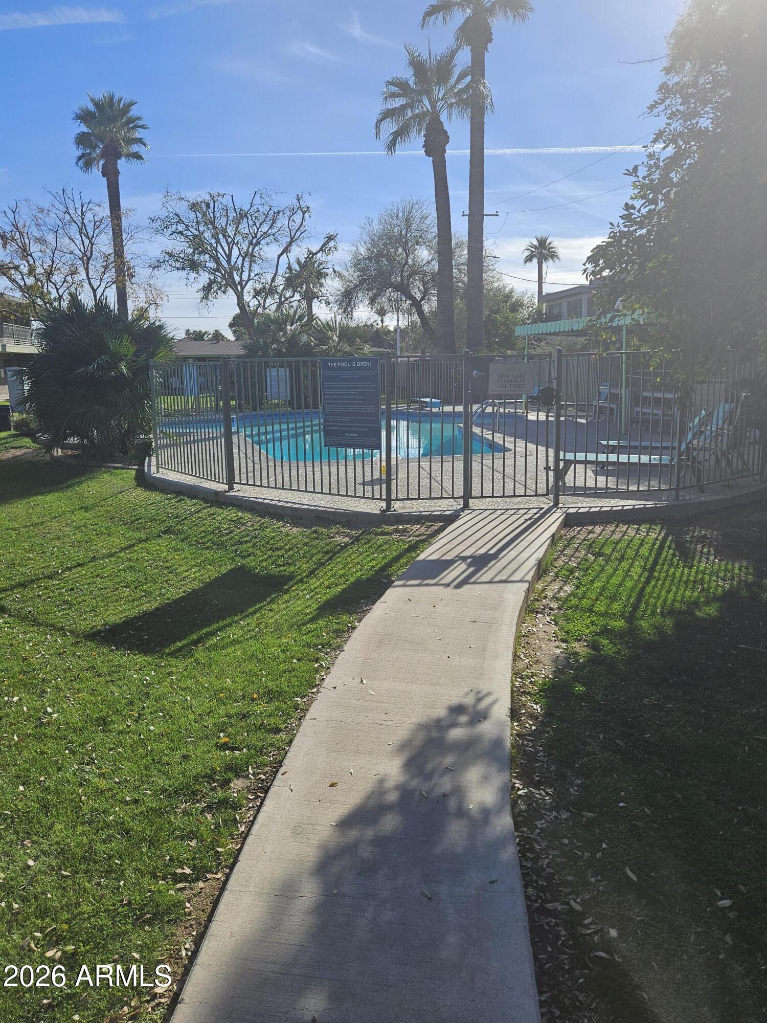 1418 East Osborn Road, Unit 25A Phoenix, AZ 85014 - Photo 1 of 13 a view of a street with a big yard and a fountain